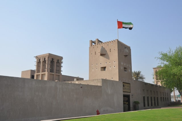 صورة يظهر فبها متحف معرض الح١ارات والعلم الاماراتي فوقه يرفرف